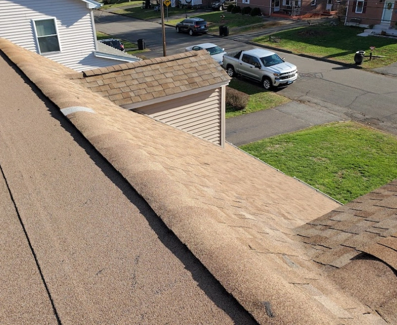 Aged roof with severe signs of wear before replacement by Spangler Roof Systems